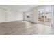 Bright living space featuring hardwood flooring, large windows and sliding glass door at 1613 Bloom St, Brighton, CO 80601