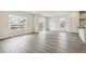 Bright living space featuring hardwood flooring, large windows and sliding glass door at 1613 Bloom St, Brighton, CO 80601