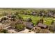 Aerial view of a neighborhood with tree coverage, a golf course, and multi-car driveways at 6668 Fairways Dr, Longmont, CO 80503
