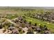 Aerial view of a vibrant community featuring a golf course, tennis courts, and well-maintained landscapes at 6668 Fairways Dr, Longmont, CO 80503