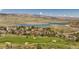 Stunning aerial view of lakeside community featuring a golf course and scenic mountain views at 6668 Fairways Dr, Longmont, CO 80503