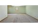 Carpeted basement with painted cinder block and drywall, and a window providing natural light at 6668 Fairways Dr, Longmont, CO 80503