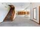 Basement featuring carpet, built-in shelves, window views, and stairway access at 6668 Fairways Dr, Longmont, CO 80503