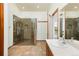 Spacious bathroom featuring large walk-in shower, tile floors and a wide vanity at 6668 Fairways Dr, Longmont, CO 80503