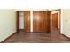 A bedroom with hardwood floors and several wooden closets with panel doors at 6668 Fairways Dr, Longmont, CO 80503