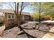 Charming single-story home with manicured front yard featuring mature trees and attractive rock landscaping at 6668 Fairways Dr, Longmont, CO 80503