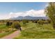 Picturesque golf course with well-maintained fairways, mature trees, and beautiful mountain views at 6668 Fairways Dr, Longmont, CO 80503