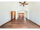 A large great room with high ceilings, arched doorways, and hardwood floors at 6668 Fairways Dr, Longmont, CO 80503