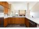Spacious kitchen features stainless steel appliances, wooden cabinets, and quartz countertops at 6668 Fairways Dr, Longmont, CO 80503