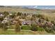 Spacious homes with decks overlooking beautifully landscaped yards with mature trees and solar panels at 6668 Fairways Dr, Longmont, CO 80503