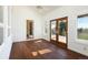 Bright sunroom with wood floors, white shiplap walls, and access to a private outdoor deck at 6668 Fairways Dr, Longmont, CO 80503