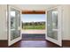 A pair of double doors open to a wood deck overlooking the neighborhood at 6668 Fairways Dr, Longmont, CO 80503