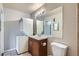 Well lit bathroom with stacked washer/dryer, vanity, and generous mirror at 10150 E Virginia Ave # 301, Denver, CO 80247