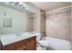 Modern bathroom with a tile shower over tub and wood vanity at 10150 E Virginia Ave # 301, Denver, CO 80247