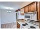 Bright dining area features hardwood floors and chandelier lighting next to the kitchen space at 10150 E Virginia Ave # 301, Denver, CO 80247