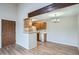 Dining area view with wooden beam, kitchen cabinets, laminate flooring and chandelier at 10150 E Virginia Ave # 301, Denver, CO 80247