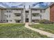 Exterior view of apartments with light-colored siding, multiple balconies and landscaped lawn at 10150 E Virginia Ave # 301, Denver, CO 80247