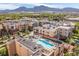 Aerial view showcasing the community, pool, spa, and surrounding landscape with mountain views at 3701 Arapahoe Ave # 318, Boulder, CO 80303