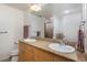Bright bathroom featuring a double vanity, granite countertops, and a large mirror at 3701 Arapahoe Ave # 318, Boulder, CO 80303