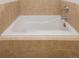 Close up on a pristine, white bathtub with tile surround at 3701 Arapahoe Ave # 318, Boulder, CO 80303