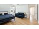Well-lit bedroom features a comfortable bed, modern sofa, and a large window with neighborhood views at 3701 Arapahoe Ave # 318, Boulder, CO 80303