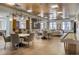 Large, sunny community room with tables, chairs, and a shuffleboard for residents to enjoy at 3701 Arapahoe Ave # 318, Boulder, CO 80303