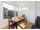 Bright dining area featuring a wooden table, large window, and an adjacent living room at 3701 Arapahoe Ave # 318, Boulder, CO 80303
