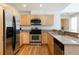 A modern kitchen features stainless steel appliances, wood floors, and granite counters at 3701 Arapahoe Ave # 318, Boulder, CO 80303
