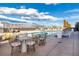 The rooftop pool area features multiple hot tubs, tables, and mountain views at 3701 Arapahoe Ave # 318, Boulder, CO 80303