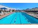 Stunning rooftop pool with lap lanes, lounge chairs, umbrellas, and mountain views at 3701 Arapahoe Ave # 318, Boulder, CO 80303