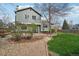 Serene backyard with a wood deck, a lush lawn, mature landscaping, and a stone pathway, perfect for relaxation at 6167 S Pierson St, Littleton, CO 80127
