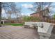 Spacious backyard featuring a wood deck with built-in seating and a well-maintained lawn, perfect for outdoor entertaining at 6167 S Pierson St, Littleton, CO 80127