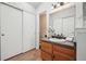 Bathroom with vanity and sliding closet, modern finishes, neutral paint at 6167 S Pierson St, Littleton, CO 80127