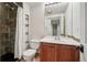 Bathroom with white vanity, stone shower, and a large mirror at 6167 S Pierson St, Littleton, CO 80127