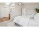 Cozy bedroom with plush carpet, a ceiling fan, a skylight, and a doorway to a full ensuite bathroom at 6167 S Pierson St, Littleton, CO 80127