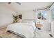 Bright bedroom features plush carpet, stylish nightstands and decor, and a large window with curtains at 6167 S Pierson St, Littleton, CO 80127