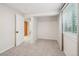 Neutral bedroom with gray carpet, a window with blinds, and an open door to the hallway at 6167 S Pierson St, Littleton, CO 80127