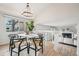 Open concept dining room with chandelier lighting and view to the main living area at 6167 S Pierson St, Littleton, CO 80127