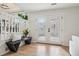 Bright entryway with hardwood floors, a bench, double doors, and view to the dining room and staircase at 6167 S Pierson St, Littleton, CO 80127