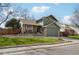 Charming two-story home with a lush green lawn, stone accents and a two car garage at 6167 S Pierson St, Littleton, CO 80127