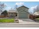 Charming two-story home with a lush green lawn, stone accents and a two car garage at 6167 S Pierson St, Littleton, CO 80127