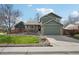 Charming two-story home with a lush green lawn, stone accents and a two car garage at 6167 S Pierson St, Littleton, CO 80127