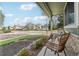 Inviting front porch with stylish wicker chairs and a view of the peaceful neighborhood at 6167 S Pierson St, Littleton, CO 80127