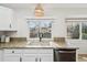 Bright kitchen featuring granite countertops, stainless steel appliances, and a stylish wicker light fixture at 6167 S Pierson St, Littleton, CO 80127