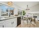 Bright kitchen with large windows, granite countertops and an adjacent dining area for easy meals at 6167 S Pierson St, Littleton, CO 80127
