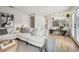 Comfortable living room with a plush white sofa and an entryway bench with hardwood floors at 6167 S Pierson St, Littleton, CO 80127