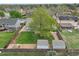 Aerial view of a fenced backyard with two storage sheds, surrounded by lush greenery and mature trees at 18714 E Utah Cir, Aurora, CO 80017