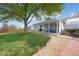 This is a backyard featuring a covered patio and a large tree, perfect for outdoor gatherings at 18714 E Utah Cir, Aurora, CO 80017