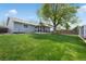 A large backyard with a well-maintained lawn and a patio, ideal for relaxation and outdoor activities at 18714 E Utah Cir, Aurora, CO 80017