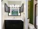 Well-lit bathroom with sleek vanity, modern fixtures, and tiled shower with glass door at 18714 E Utah Cir, Aurora, CO 80017